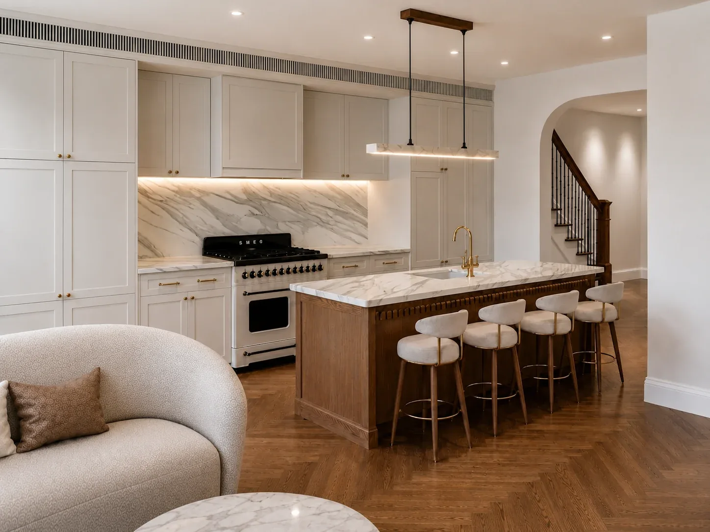 Kitchen with an oak and marble island, a marble splashback and herringbone floors, the staircase beyond, Everleigh, Balmain