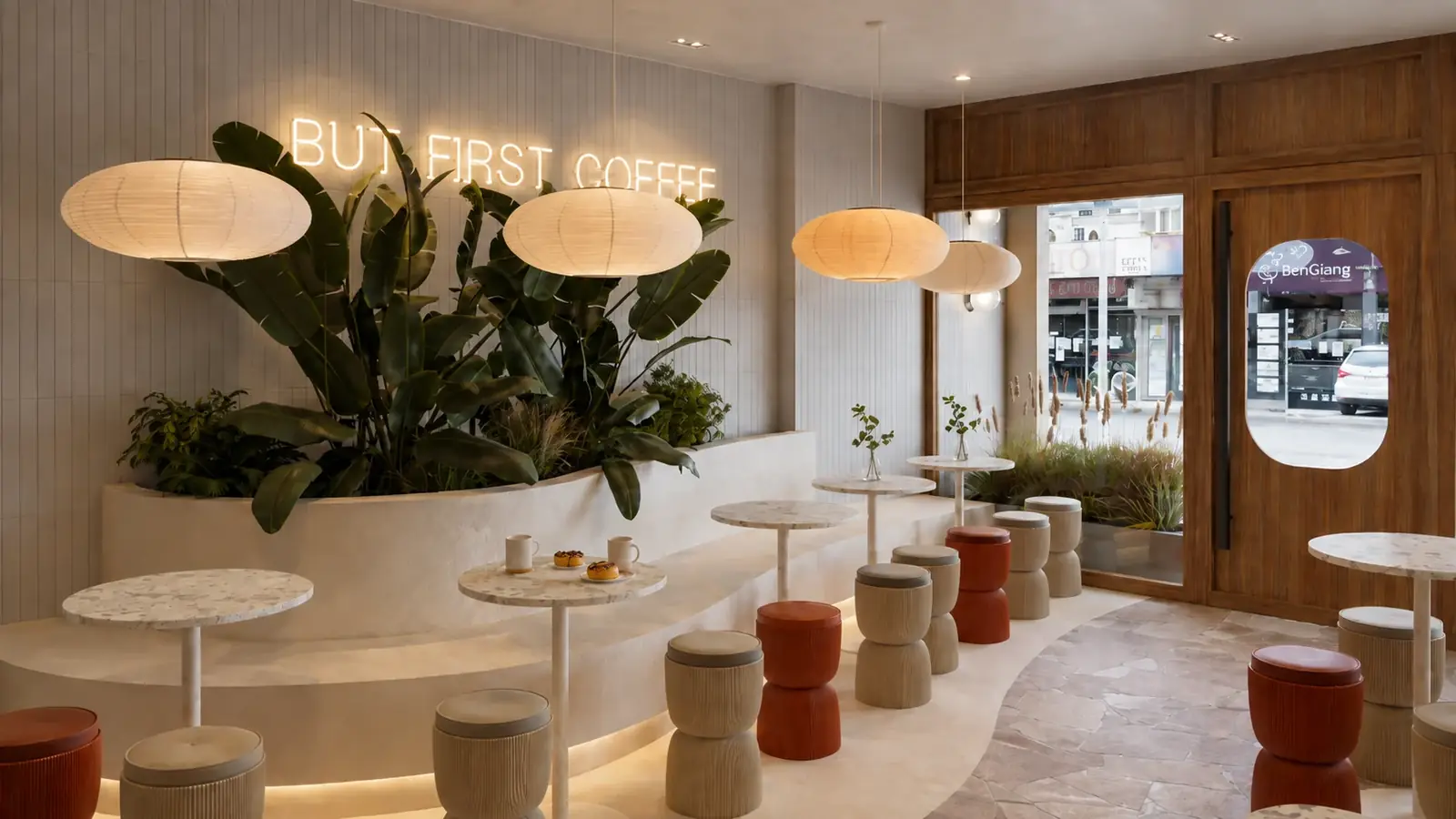 Inside Harry's House, a dessert shop in Bankstown: a curved planter bench, paper lanterns, round tables and orange stools