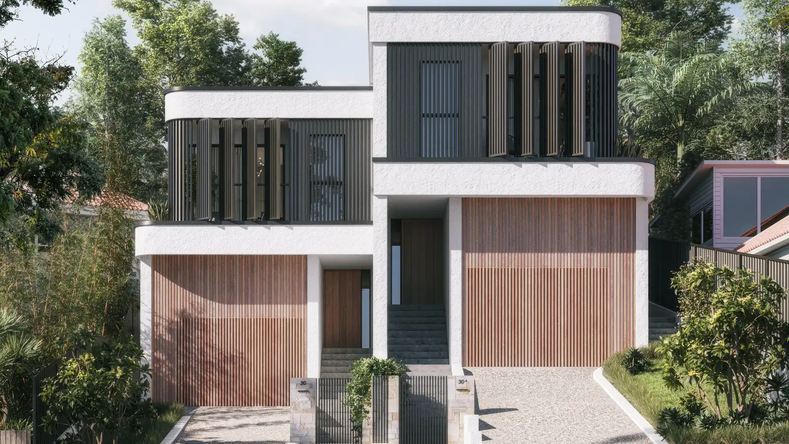 Kalandra in Wollongong: a white rendered duplex with dark battened upper floors and timber garage doors, stepping up a sloping block