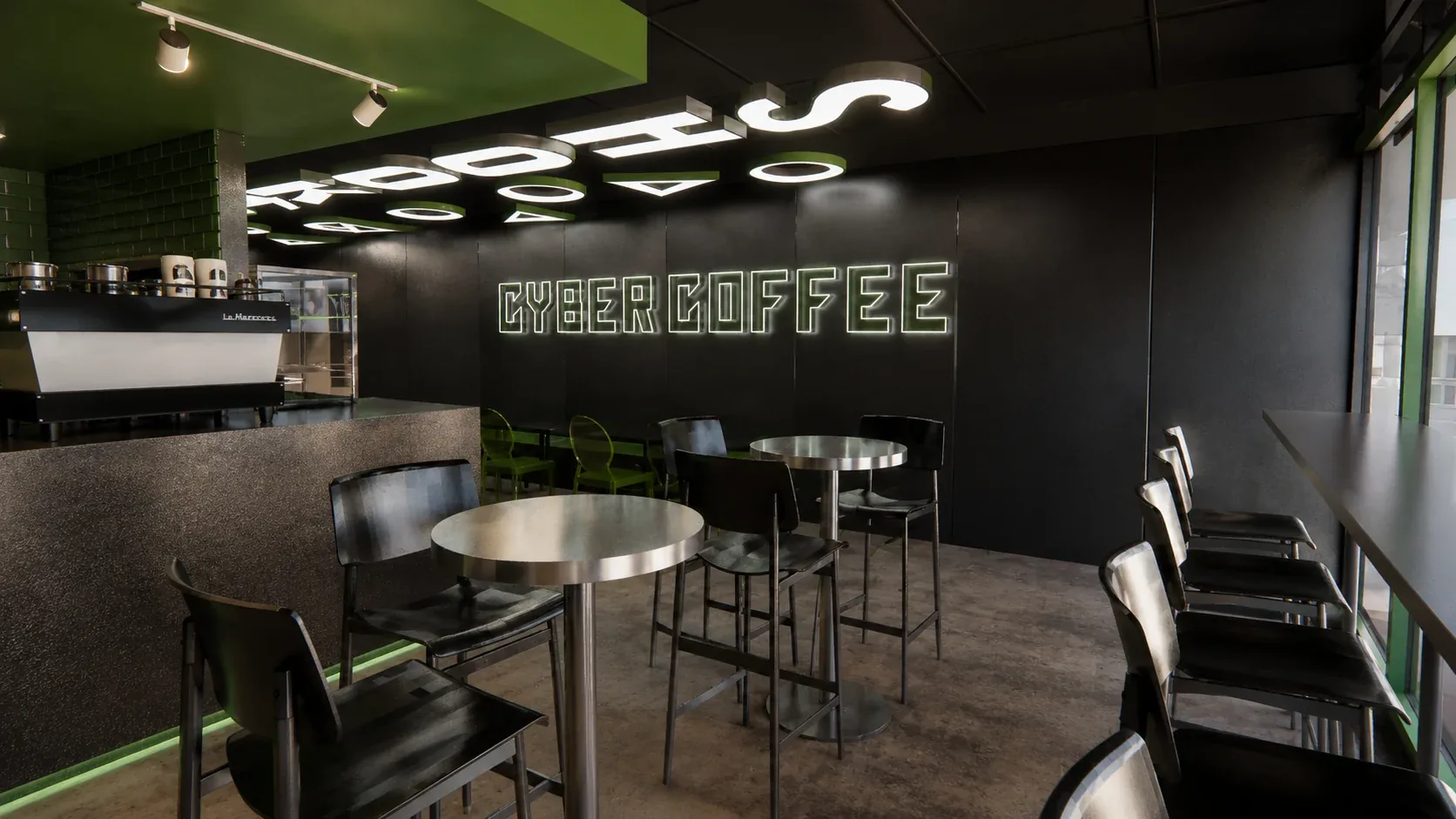 Shook Cyber Coffee in Kingsford: black walls, a green ceiling, the Cyber Coffee neon sign and stainless-steel tables and stools